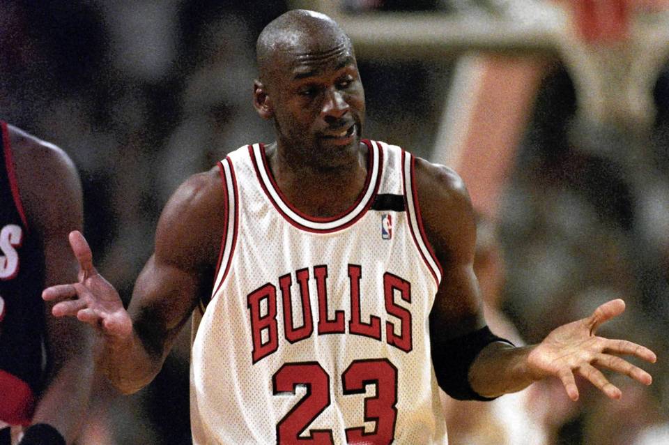 1992 FILE: The Chicago Bulls' Michael Jordan gives a shrug after sinking his sixth three-pointer during the game with Portland June 3, 1992, in Chicago. Jordan scored 35 points in the first half of the 122-89 victory over the Trailblazers in Game 1 of the NBA Finals. (Mike Blake/Reuters) ORG XMIT: SIN621R (basketball pro championship)