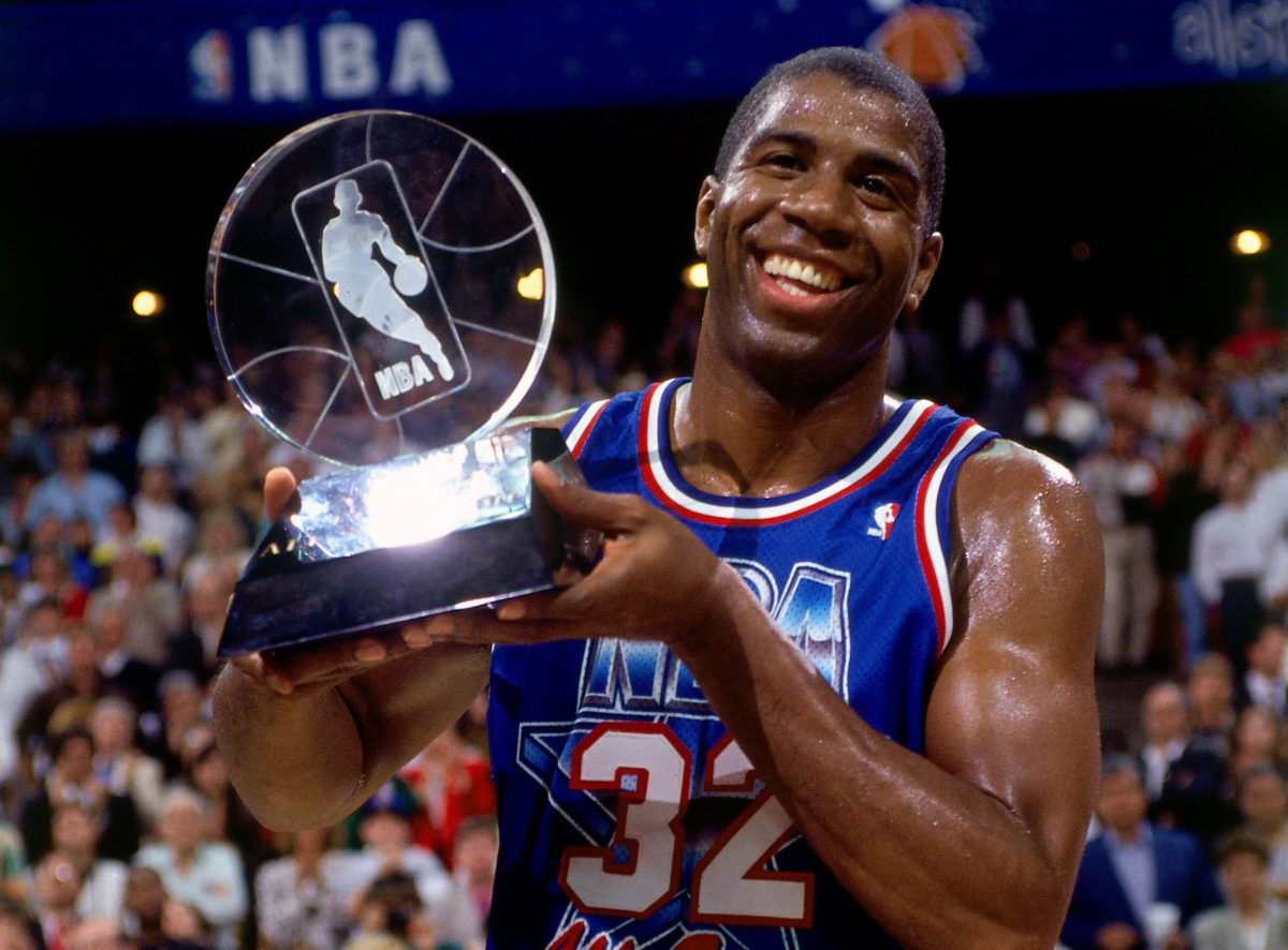 ORLANDO- FEBRUARY 9: Magic Johnson #32 of the Western Conference All-Stars holds the MVP trophy following the 1992 NBA All Star Game on February 9, 1992 at the Orlando Arena in Orlando, Florida. NOTE TO USER: User expressly acknowledges that, by downloading and or using this photograph, User is consenting to the terms and conditions of the Getty Images License agreement. Mandatory Copyright Notice: Copyright 1987 NBAE (Photo by Andrew D. Bernstein/NBAE via Getty Images)